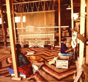 NAVAJO WOMEN WEAVE A RUG AT TRADING POST ON THE NAVAJO RESERVATION wikipedia public domain